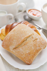 bread with coffee on white wooden background