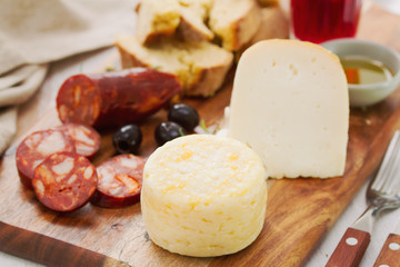 cheese with chorizo, bread and red wine