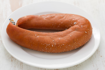 traditional portuguese sausage farinheira on white plate on white wooden background