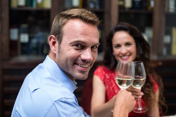 Portrait of happy couple toasting champagne flutes