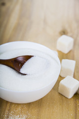 Sugar and wooden spoon in a bowl