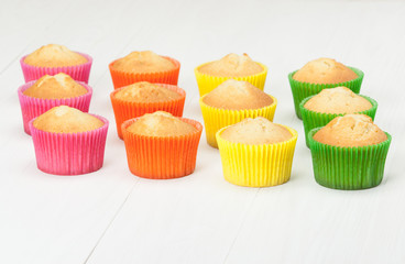 Homemade Colorful Plain Cupcakes On White Table.