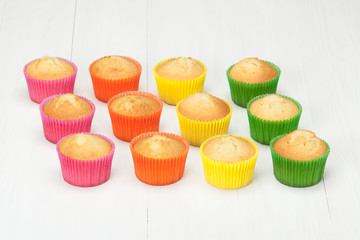 Homemade Colorful Plain Cupcakes On White Table.