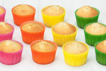 Homemade Colorful Plain Cupcakes On White Table.