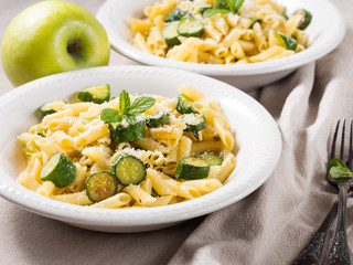 Pennette pasta with zucchini, mint leaves and parmesan