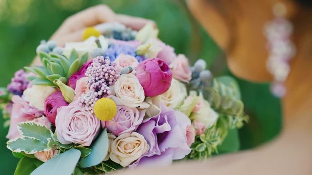 Bride looking at bouquet, view over shoulder
