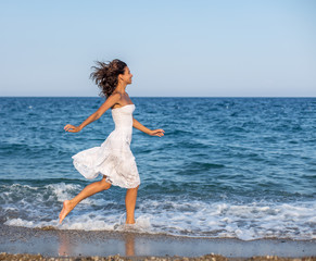 Woman running along the beach.