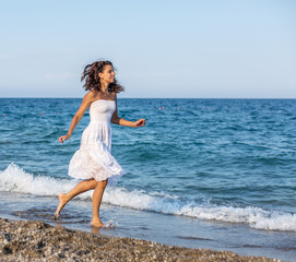 Fototapeta na wymiar Woman running along the beach.