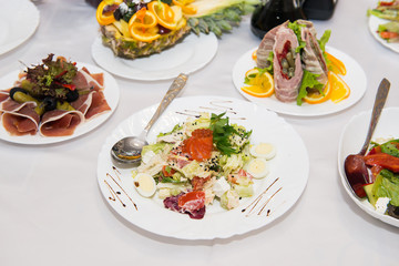 healthy food salad with vegetables and tuna fish. Salad with salmon, caviar, vegetables and quail eggs.