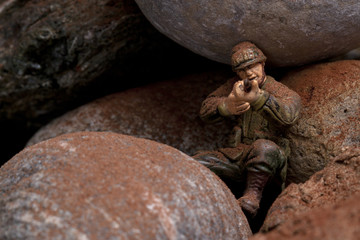 a soldier hiding on the rocks