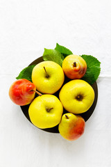 Pears and apples in a dishon white