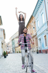 happy couple riding a white bike