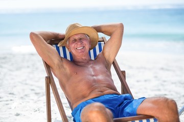 Mature man relaxing on a deck chair