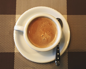 Cup of coffee in a white cup, selective focus