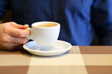 Cup of coffee in businessman hand, selective focus