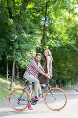 happy lovers enjoying the sunny weather by bike