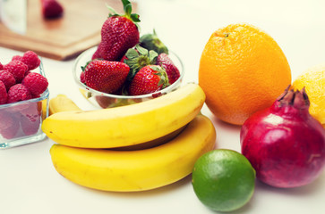 Fototapeta na wymiar close up of fresh fruits and berries on table