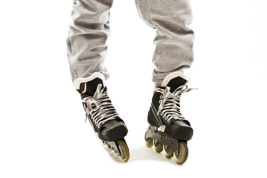 Close up a Boy Legs in Roller Skates. Isolated On White Background 