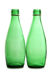 Green bottles and glasses on a white background