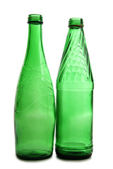 Green bottles and glasses on a white background