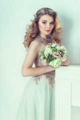 Beautiful bride in wedding dress. Portrait of young bride. Studio shot.
