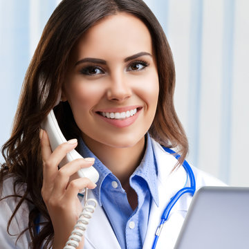 Smiling young doctor on phone