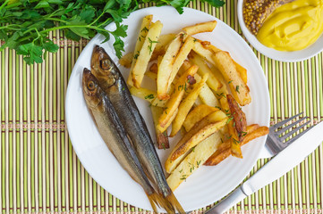 Fried potatoes (fries) "at home" with a small smoked fish. 