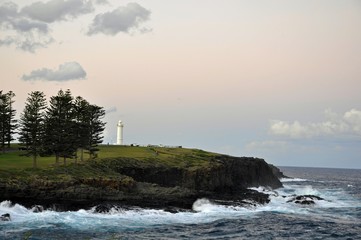 Kiama sunset, view across the Storm Bay towards the lighthouse on Blowhole Point, NSW Australia 