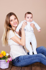 Mother and little son in studio with flowers