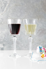 red and white wine in glasses on a white table