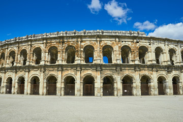 Fototapeta na wymiar Roman Arena (Amphitheater) in Nimes and bullfighter sculpture, P