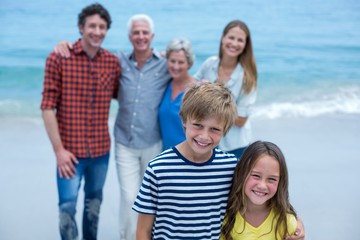 Obraz premium Portrait of siblings with family standing in background