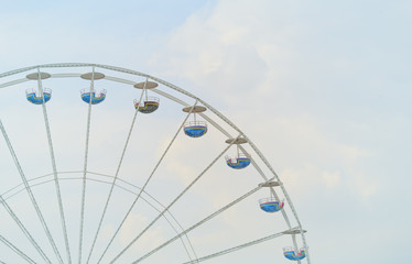 ferris wheel against sky and clouds