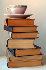 coffee cup on stack of old books