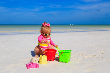 cute little girl playing on summer beach