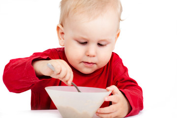 Little baby eating with spoon