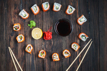 Sushi roll with salmon on wood background. Top view
