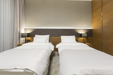 Interior of a new modern hotel bedroom in the evening