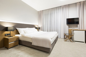 Fototapeta na wymiar Luxury hotel bedroom in the evening
