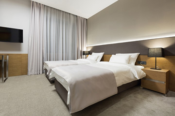 Fototapeta na wymiar Luxury hotel bedroom in the evening