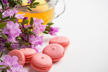 Pink macaroons on the white wooden background