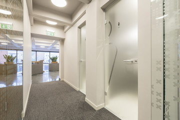 Hotel corridor with glass toilete door