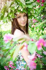 Beautiful young woman in the spring garden