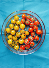 red and yellow cherry tomatoes on blue