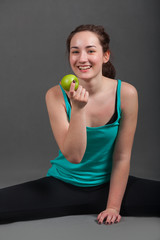 Positive beautiful woman eating an apple