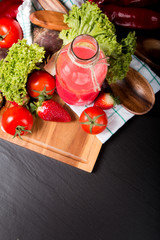 Fresh red smoothie in the glass on black stone, Lifestyle concept