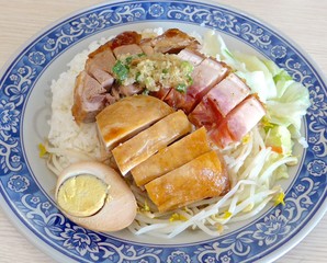 Combination of soy sauce chicken, roast duck and BBQ pork on rice