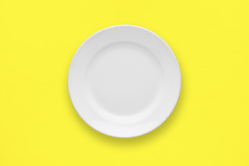 White plate on yellow table top view - 108045201