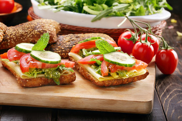Vegetarian sandwich with pesto on wooden background