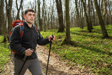 Male hiker looking to the side walking in forest